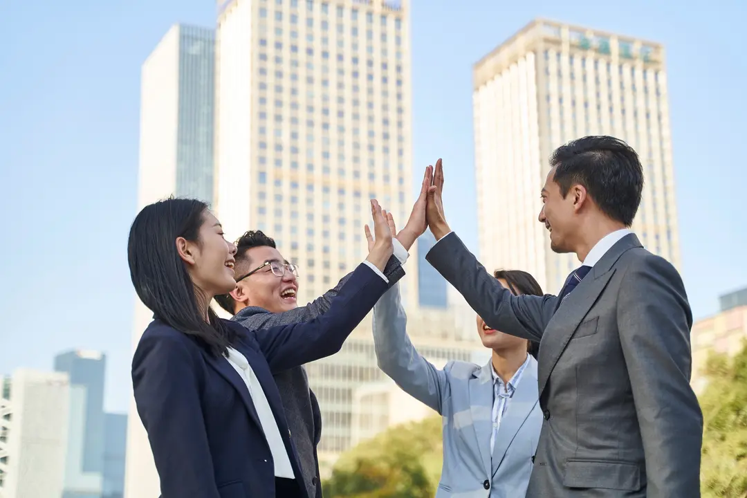 Professional diverse team posing together in modern office environment